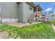 View of home's backyard, featuring a wooden deck and stairs, landscaping rock and a well-manicured lawn at 4406 Sidewinder Loop, Castle Rock, CO 80108