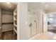 Bathroom featuring a glass-enclosed shower, walk-in closet, and neutral finishes at 4406 Sidewinder Loop, Castle Rock, CO 80108
