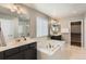 Bright bathroom featuring a soaking tub, double vanity, and ample space at 4406 Sidewinder Loop, Castle Rock, CO 80108