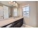 Well-lit bathroom with a large vanity mirror, ample countertop space, and a window, providing a functional and bright space at 4406 Sidewinder Loop, Castle Rock, CO 80108