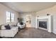 Cozy sitting area features a fireplace, comfortable chairs, and ample natural light at 4406 Sidewinder Loop, Castle Rock, CO 80108