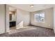 Neutral bedroom featuring soft carpet, bright windows, and an ensuite bathroom entrance for added convenience at 4406 Sidewinder Loop, Castle Rock, CO 80108