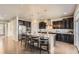 Modern kitchen with dark cabinets, granite countertops, and a large island at 4406 Sidewinder Loop, Castle Rock, CO 80108