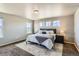 Spacious main bedroom with a large bed, stylish decor, and ample natural light from several windows at 4406 Sidewinder Loop, Castle Rock, CO 80108
