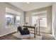 Bright office space with large windows, plush chair, and functional workspace at 4406 Sidewinder Loop, Castle Rock, CO 80108