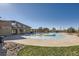 Community pool and pavilion area with a shallow sunbathing platform with a large, irregular pool at 4406 Sidewinder Loop, Castle Rock, CO 80108