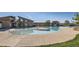 Spacious community pool area with shallow sunbathing platform and pavilion in background at 4406 Sidewinder Loop, Castle Rock, CO 80108