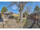 The backyard features an area for relaxing and mature trees at 12995 W Chenango Ave, Morrison, CO 80465