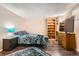 Basement bedroom with dark wood floors and a media center at 12995 W Chenango Ave, Morrison, CO 80465