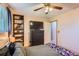 Cozy bedroom with a built-in shelf and a TV on top of a dark wood dresser at 12995 W Chenango Ave, Morrison, CO 80465