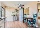 Charming dining area featuring wood-look floors, a ceiling fan, and a view to another room at 12995 W Chenango Ave, Morrison, CO 80465