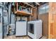 This laundry room includes a washer, dryer, and water heater at 12995 W Chenango Ave, Morrison, CO 80465