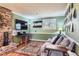 Comfortable living room with wood floors, a large TV, and a Colorado-themed decor at 12995 W Chenango Ave, Morrison, CO 80465
