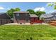 Grassy backyard featuring lawn, rock, a deck, a fence, and a two-story home at 12908 Hudson St, Thornton, CO 80241
