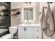Bathroom with modern fixtures, floating shelves, and dark-framed glass shower at 12908 Hudson St, Thornton, CO 80241