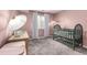 Charming pink Bedroom with crib, changing table, and neutral carpet at 12908 Hudson St, Thornton, CO 80241