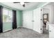 Light-filled bedroom featuring a ceiling fan, gray carpet, closet, and view of the outside through the window at 12908 Hudson St, Thornton, CO 80241