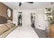 Bedroom with a walk-in closet, and open bathroom with modern finishes at 12908 Hudson St, Thornton, CO 80241