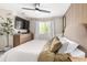Bedroom featuring a wood accent wall, large dresser and neutral color scheme at 12908 Hudson St, Thornton, CO 80241
