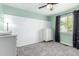Bright bedroom with white board and batten accent wall, ceiling fan, and neutral carpet at 12908 Hudson St, Thornton, CO 80241
