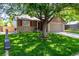 Charming home with a lush green lawn, mature tree, and a well-maintained front yard, enhancing its curb appeal at 12908 Hudson St, Thornton, CO 80241