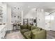 Open-concept living area with stylish furnishings, modern decor, and seamless flow to the kitchen at 12908 Hudson St, Thornton, CO 80241