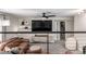 Upstairs living room featuring a comfortable sofa, entertainment center, and adjacent bathroom access at 12908 Hudson St, Thornton, CO 80241