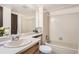 Clean bathroom with a shower-tub combo, modern fixtures, and neutral color palette at 18064 E Ohio Ave # 103, Aurora, CO 80017