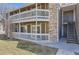 Multi-level condominium with balconies, stone accents, and well-maintained landscaping at 18064 E Ohio Ave # 103, Aurora, CO 80017