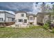 Spacious backyard with a patio area, surrounded by lush greenery, a wooden fence, and neighboring houses at 20112 E Grand Pl, Aurora, CO 80015