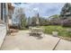 Backyard patio featuring outdoor seating and an umbrella, surrounded by a well-maintained lawn and a wooden fence at 20112 E Grand Pl, Aurora, CO 80015