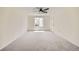 Spacious bedroom with neutral carpeting, a ceiling fan, and ample natural light from a window at 20112 E Grand Pl, Aurora, CO 80015