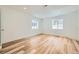 Well-lit bedroom with recessed lighting, two windows, and light wood floors, creating a bright and airy space at 20112 E Grand Pl, Aurora, CO 80015