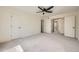 Large bedroom with neutral carpeting, a ceiling fan, and multiple closets for storage at 20112 E Grand Pl, Aurora, CO 80015