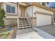 Close-up of the home's entryway with stairs leading to the front door and an ADT security sign at 20112 E Grand Pl, Aurora, CO 80015