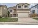 Charming two-story home with a two-car garage, a cozy entrance, and landscaped front yard at 20112 E Grand Pl, Aurora, CO 80015