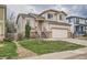 Inviting two-story home with a well-maintained lawn, a two-car garage, and a welcoming entrance at 20112 E Grand Pl, Aurora, CO 80015