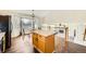 Bright eat-in kitchen featuring a center island, sleek countertops, and a bay window overlooking the neighborhood at 20112 E Grand Pl, Aurora, CO 80015