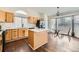 Bright kitchen with stainless steel appliances, a center island, and wood floors at 20112 E Grand Pl, Aurora, CO 80015