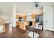 Open kitchen with stainless steel appliances, light cabinets, and wood floors at 20112 E Grand Pl, Aurora, CO 80015