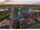 Two high rise towers with a rooftop pool during sunset at 1700 Bassett St # 2216, Denver, CO 80202