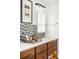 Well-lit bathroom with marble countertop, wooden cabinetry and modern fixtures at 1700 Bassett St # 2216, Denver, CO 80202