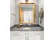 Bathroom with granite countertop, white cabinets, gold mirror, and stylish decor at 1700 Bassett St # 2216, Denver, CO 80202