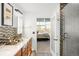 Bright, updated bathroom with a mosaic backsplash and sleek shower at 1700 Bassett St # 2216, Denver, CO 80202
