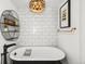 A stunning bathroom features a freestanding tub, unique light fixture and elegant decor at 1700 Bassett St # 2216, Denver, CO 80202