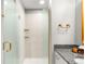 Bathroom with granite countertop, white cabinets, and glass shower with gold accents at 1700 Bassett St # 2216, Denver, CO 80202