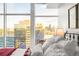 Expansive windows in the bedroom frame a breathtaking view of the vibrant city skyline at 1700 Bassett St # 2216, Denver, CO 80202