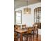 Modern dining room with a large mirror and a wooden table with 6 chairs at 1700 Bassett St # 2216, Denver, CO 80202