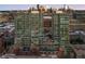 A modern high-rise apartment complex featuring sleek glass and brick accents with a distant skyline view at 1700 Bassett St # 2216, Denver, CO 80202