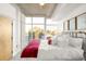 Bright bedroom boasts city views from expansive windows and a comfortable layout at 1700 Bassett St # 2216, Denver, CO 80202